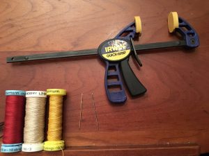 Silk & 2 weights of linen thread, cross-stitch needles, C-clamp.